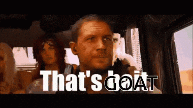 a man in a car with the words that 's goat on the screen .