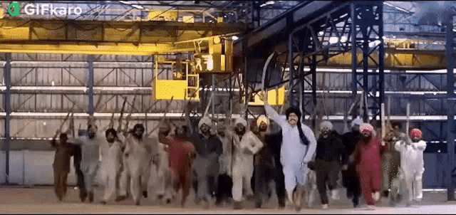 a group of people in white jumpsuits are dancing in a building with a green gifkaro logo in the corner