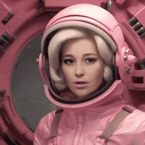 a woman in a pink space suit with a helmet on her head