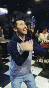 a man wearing a sweatshirt that says 51 is dancing