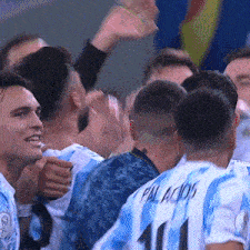 a group of soccer players are celebrating and one of them has the number 11 on the back of his jersey