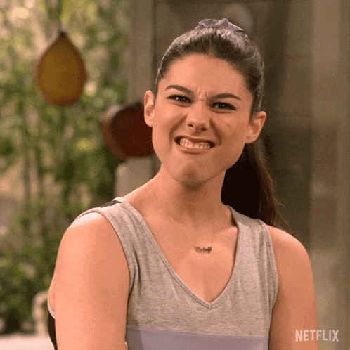 a woman is making a funny face in front of a netflix logo .