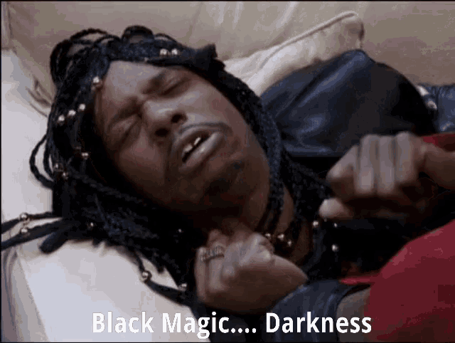 a man with braids is laying on a bed with the words black magic darkness written below him