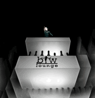 a woman is standing on top of a white box that says btw lounge