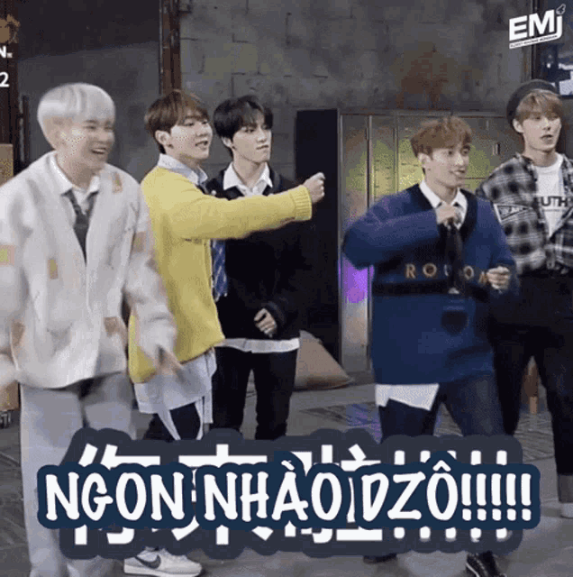 a group of young men are dancing in front of a sign that says ngonhaoiz0