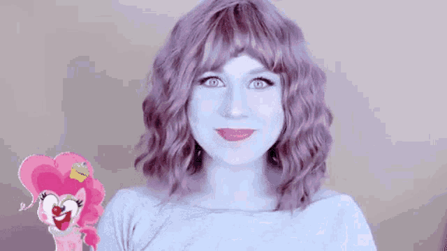 a woman with purple hair and a pinkie pie sticker on her face is making a face .