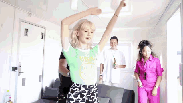 a woman wearing a green shirt that says nirvana is dancing