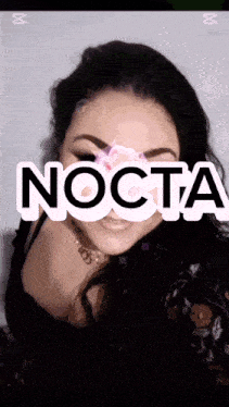 a woman is smiling with the word nocta on her face