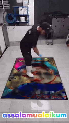 a man is standing on a colorful rug that says ' assalamualaikum ' on the bottom