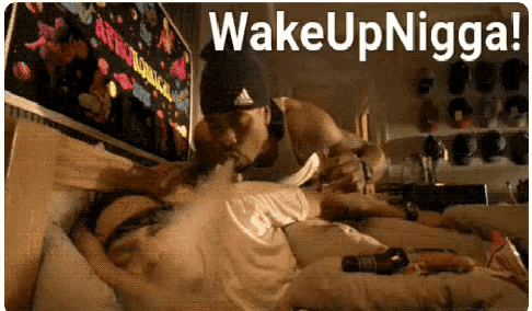 a man is licking a woman 's breast with the words wake up nigga written above him