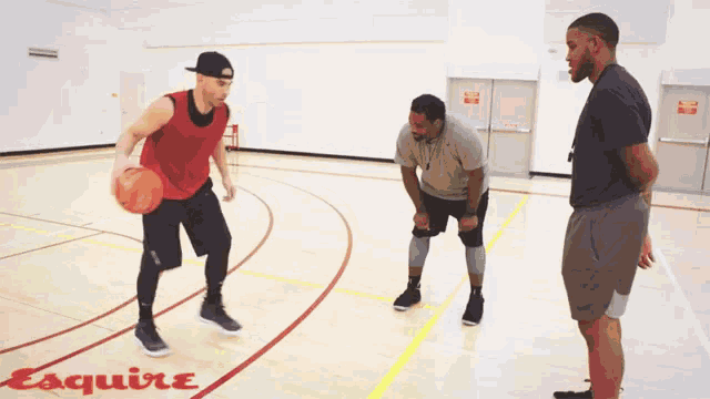 a man dribbles a basketball on a court with esquire written on it