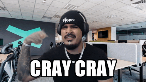 a man wearing headphones and a black beanie says cray cray