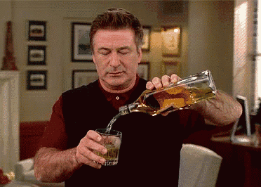a man is pouring whiskey into a glass
