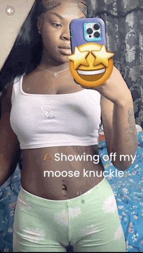 a woman is taking a picture of herself in a mirror with the caption showing off her moose knuckle