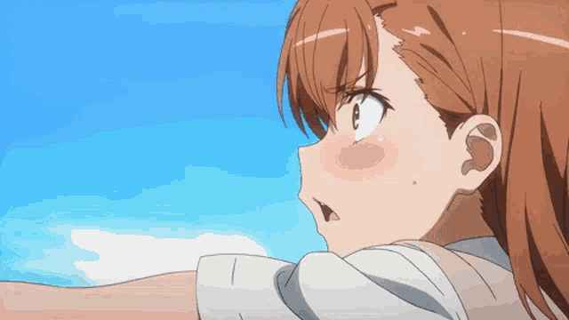 a close up of a girl 's face with a blue sky behind her