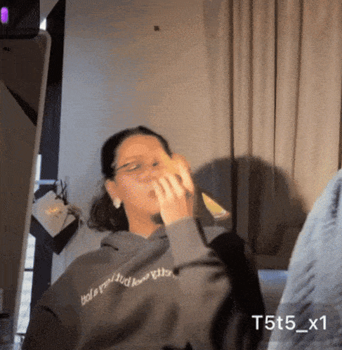 a person wearing a hoodie that says t5t5_x1