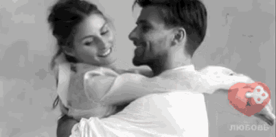 a man is carrying a woman in his arms and they are hugging each other .