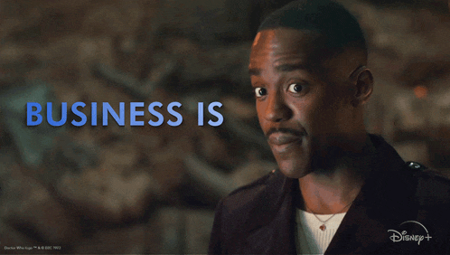 a man in a black jacket with the words business is booming above him