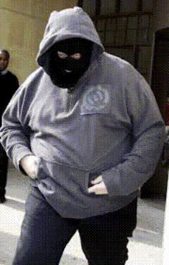 a man wearing a mask and a hoodie with a circle on the back