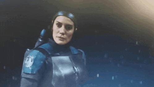 a close up of a woman in a blue armor