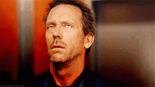 a man with a beard is making a funny face and looking up .