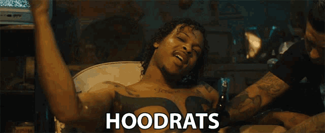 a man with a tattoo on his chest has the word hoodrats on the bottom