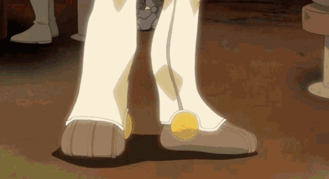 a close up of a person 's feet with a yellow circle on the bottom of the shoe