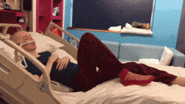 a person laying in a hospital bed with a sticker on the side that says ' ss ' on it