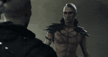 a man with a braided ponytail looks at another man in armor