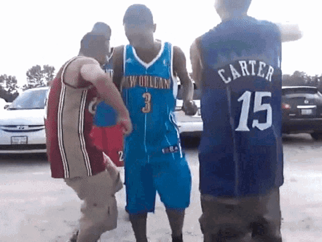 a man wearing a jersey that says carter 15 stands in a parking lot
