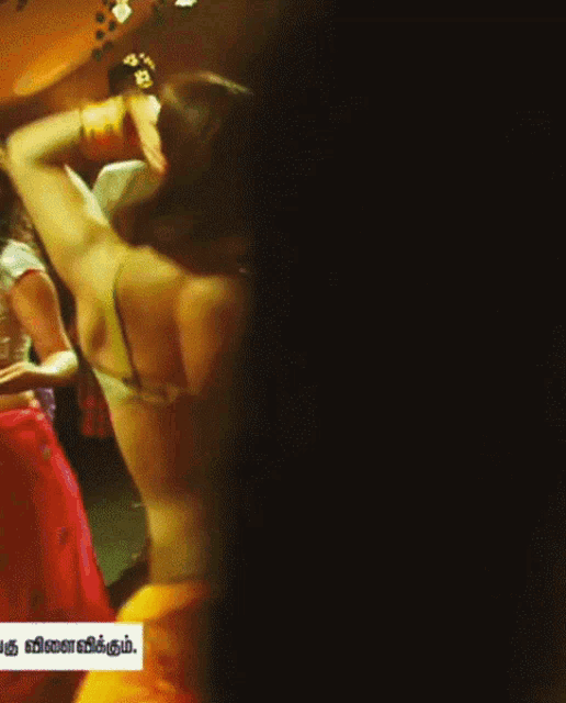 a woman is dancing in front of a sign that says ' '