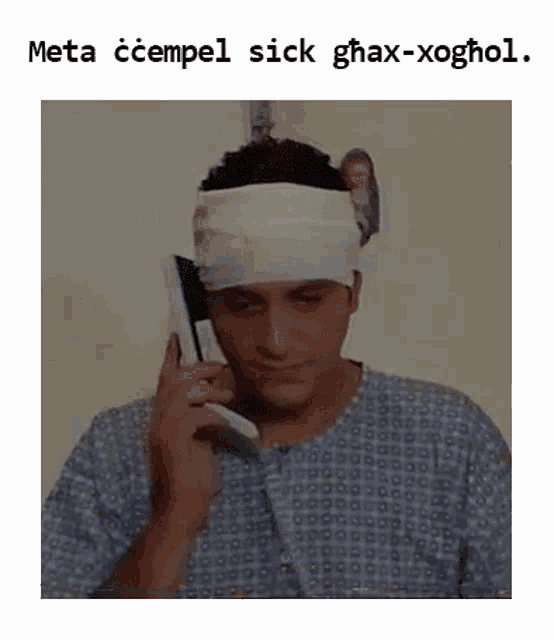 a man with a bandage on his head talking on a cell phone .