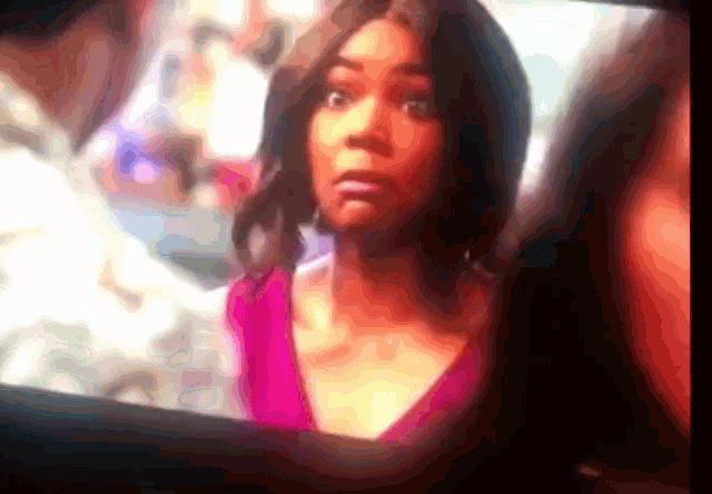 a blurry picture of a woman in a pink dress
