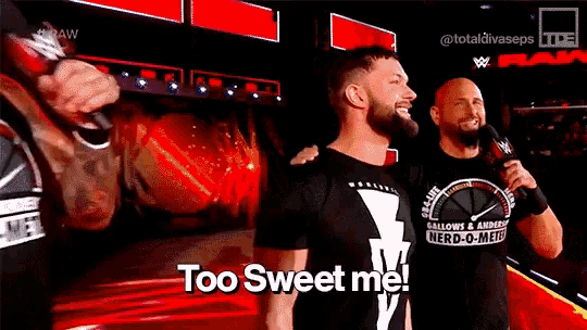two men are standing next to each other on a stage and one of them is holding a microphone and says too sweet me .