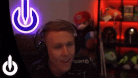 a man wearing headphones is sitting in front of a neon sign that says power .