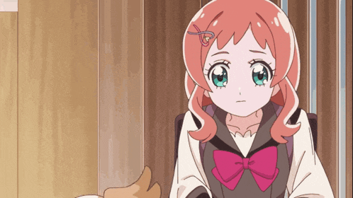 a girl with pink hair and a pink bow is sitting down