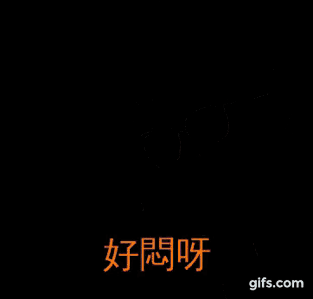 a woman wearing glasses is sitting in front of a sign in a foreign language .