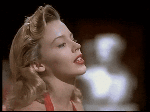 a close up of a woman 's face in a red dress