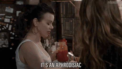 a woman is holding a jar of ketchup and says it 's an aphrodisiac