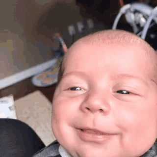 a close up of a baby 's face with a smiley face
