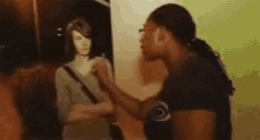 a man and a woman are standing next to each other and talking .