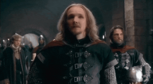 a man with long hair and a beard is wearing a crown on his head