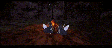 two gremlins are sitting in front of a fire in a dark forest