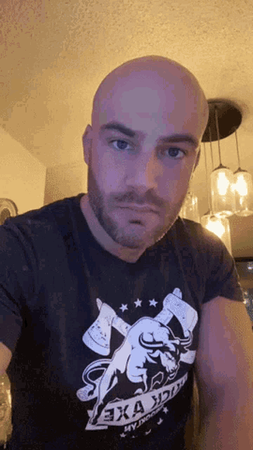 a bald man with a beard is wearing a t-shirt that says " sexa sport "