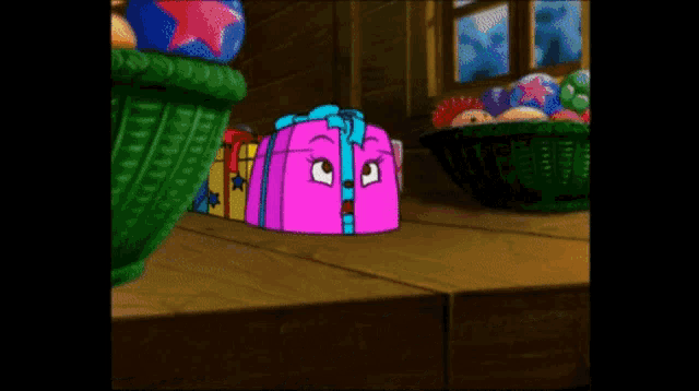a cartoon drawing of a pink gift box with a blue bow