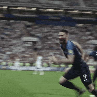 a soccer player wearing number 9 is running on the field
