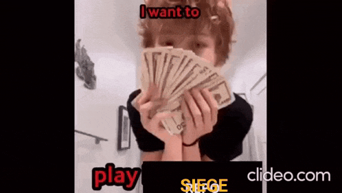 a person is holding a fan of money in front of their face .