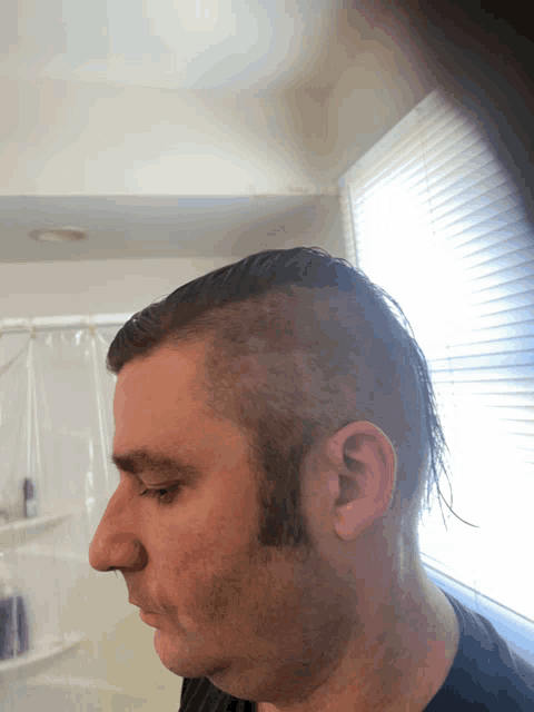 a man with a shaved head and a beard