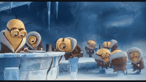 a group of minions are standing around an igloo