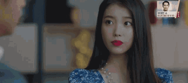 a woman with red lipstick on her lips is looking at a man in a room .